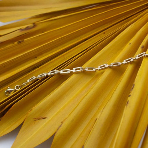 Bracelet 10K Solid Gold Chunky Anchor Link Chain on a yellow background 