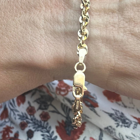 10K Solid Gold rope diamond cut bracelet on a hand with a clasp Italy stamp